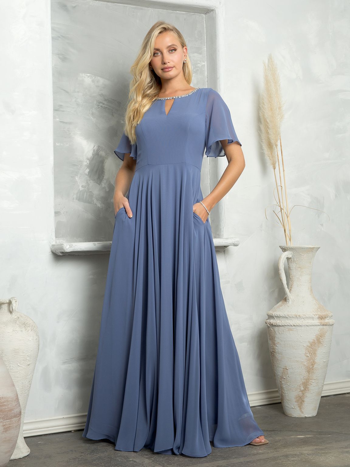 Long beaded chiffon mother of bride gown with empire waist, bell sleeves, and hidden pockets