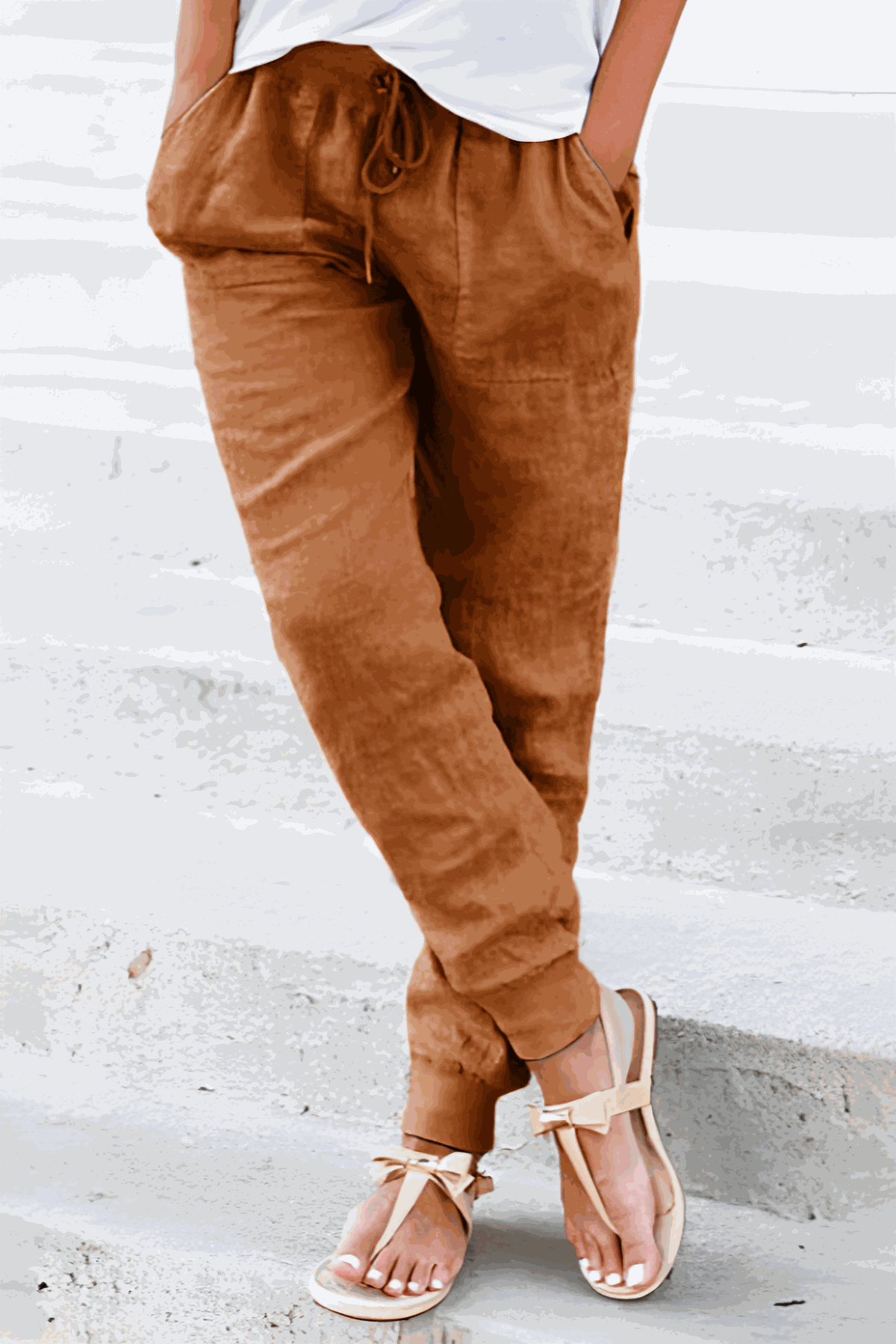 Tan women's tapered jogger pants with drawstring waist and elasticated ankle cuffs