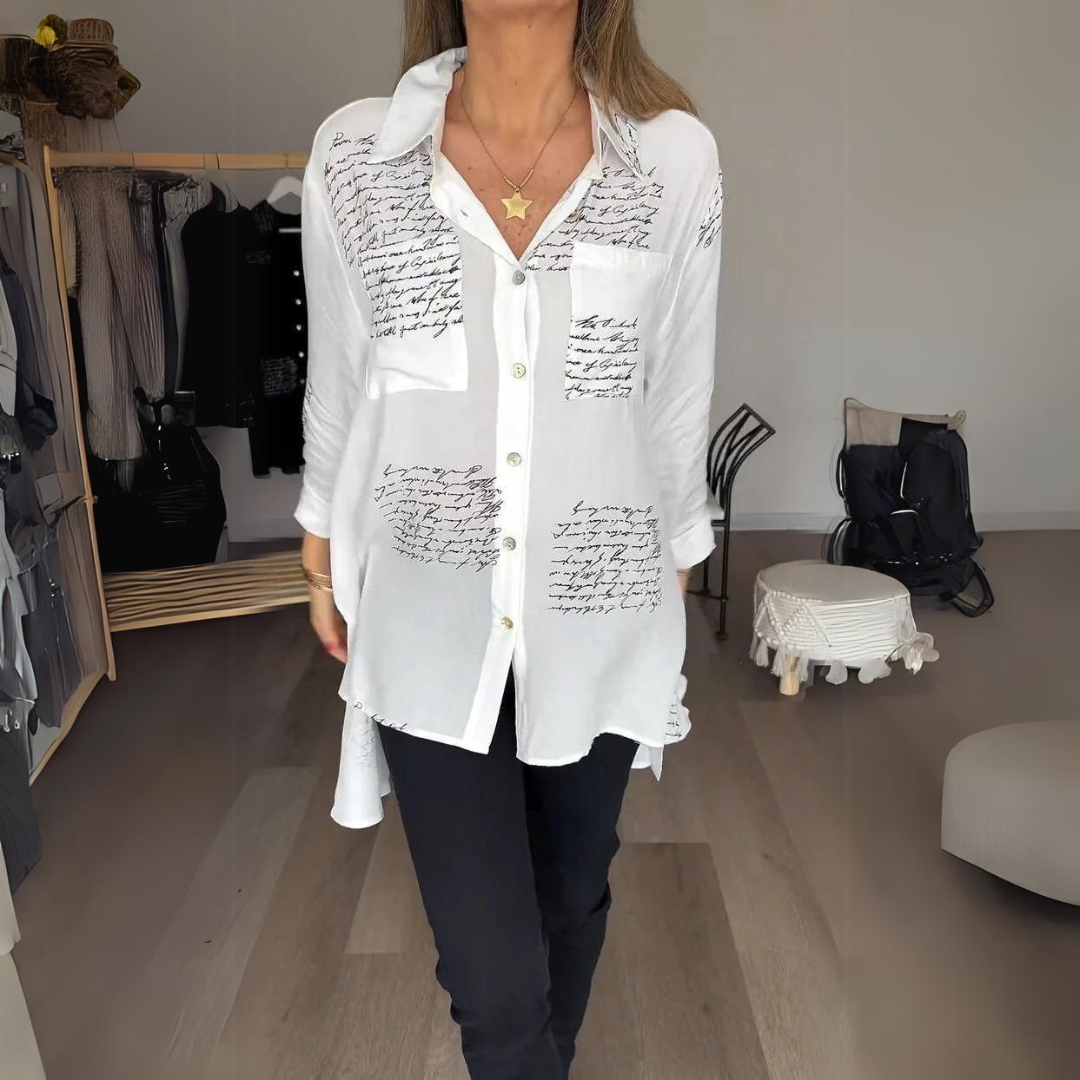 White relaxed button-up shirt with artistic handwritten script print, classic tailoring with bold personality