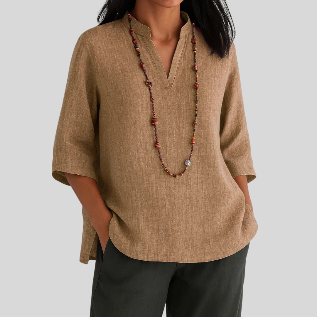 Soft green relaxed-fit blouse with breezy drape and effortless warm-weather elegance