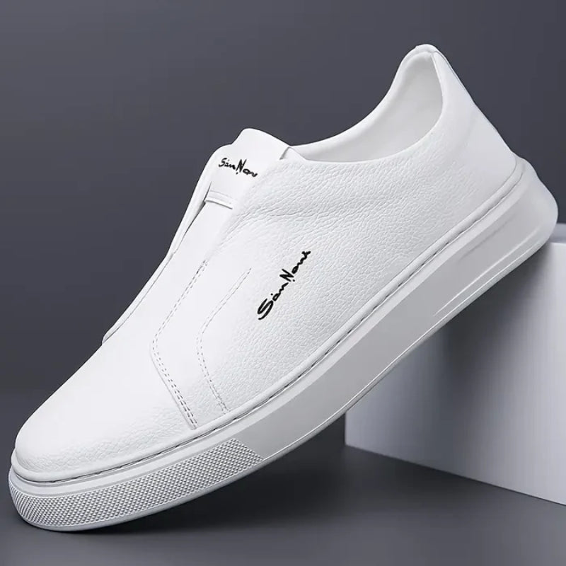 White vegan leather slip-on sneakers with minimalist design and cushioned insole for all-day comfort