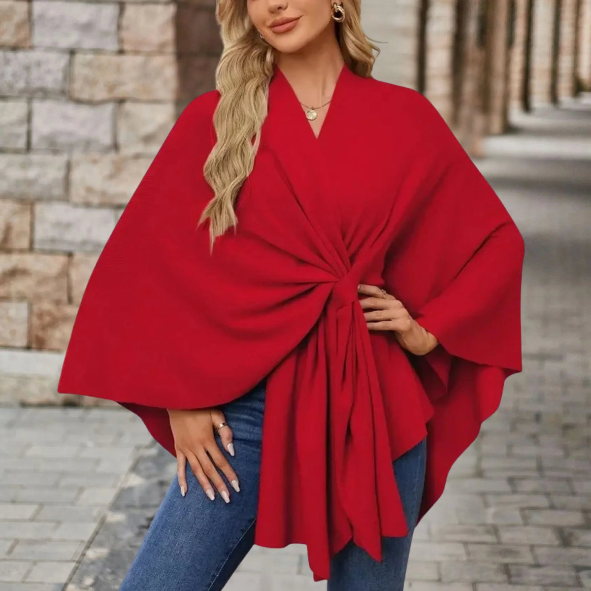 Elegant draped poncho with chic front knot in flowing silhouette, cozy sophisticated style
