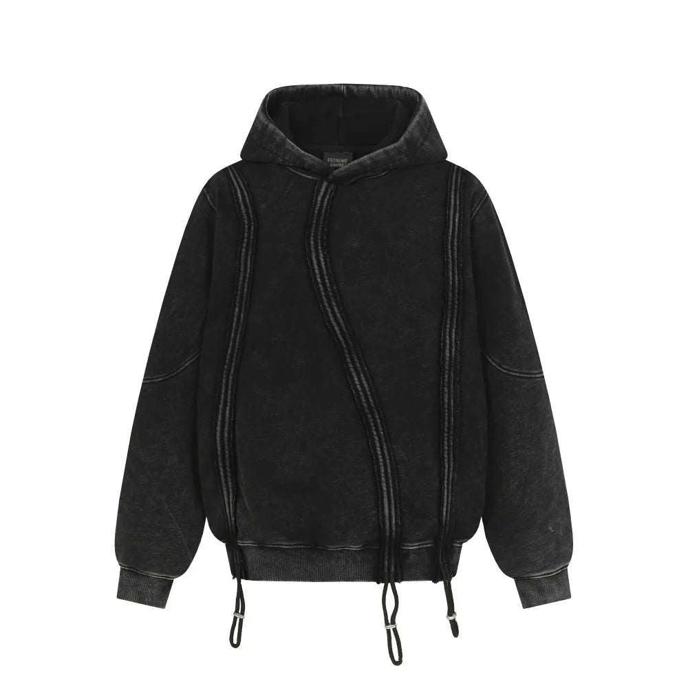 Washed black loose-fit hoodie with raw exposed seams and symmetrical stitching detail