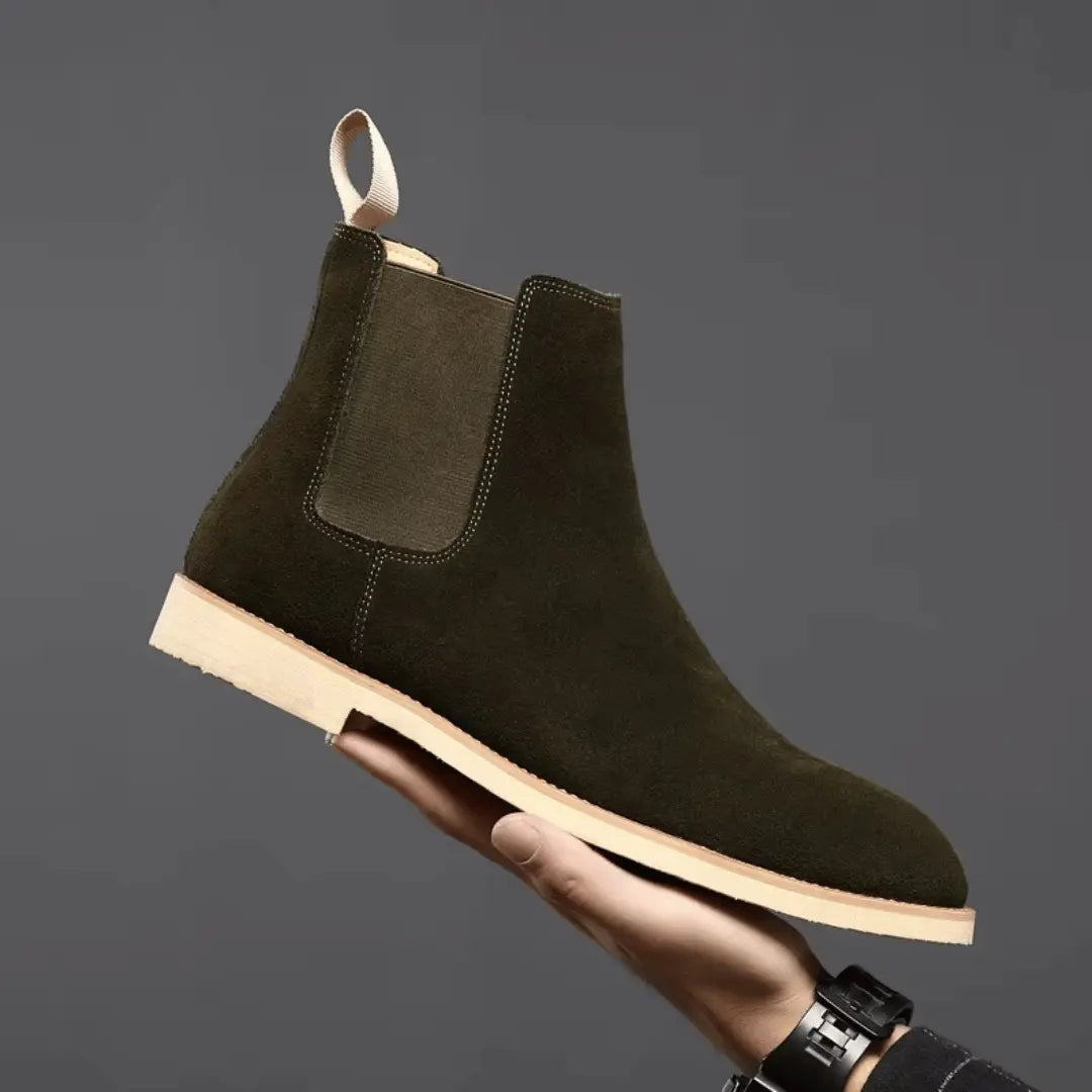 Olive green suede Chelsea boots with elastic side panels and sleek pull-tab ankle silhouette