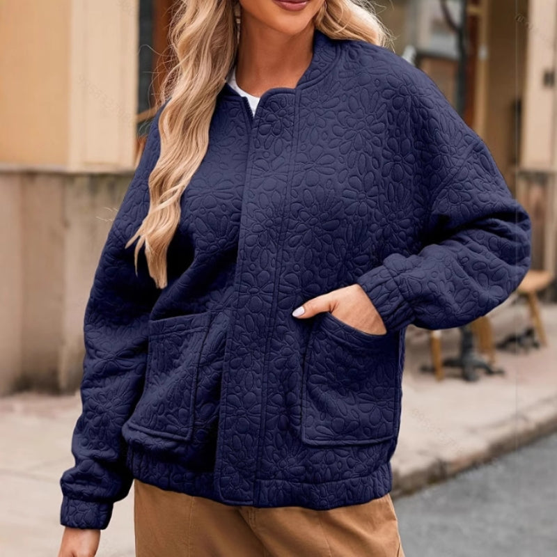 Ferine padded quilted jacket in neutral tone, clean lines, roomy pockets, easy zip closure