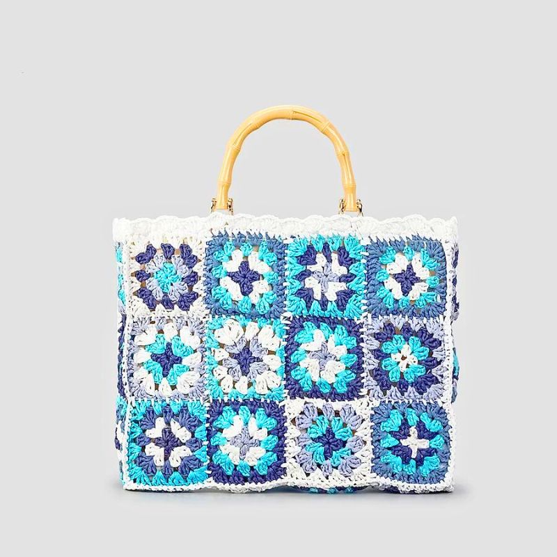 Handmade boho crochet tote bag with vibrant patchwork design and woven bamboo handle, eco-friendly