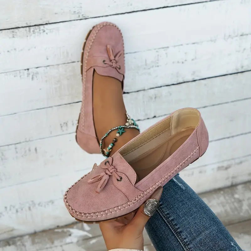 Black vegan leather slip-on loafers with classic bow detail, feminine silhouette flat shoes