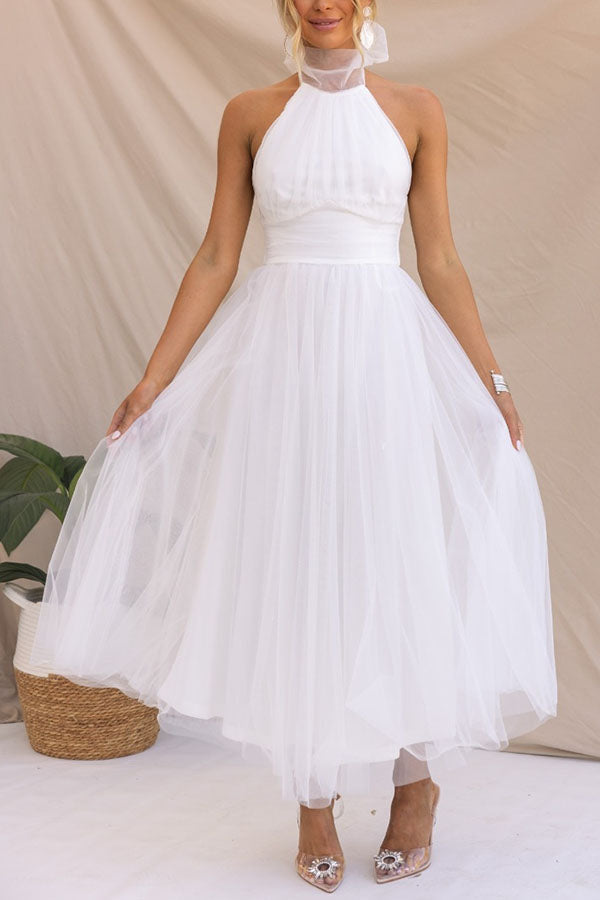 Women's ivory tulle wedding guest dress with voluminous skirt and waist-enhancing silhouette