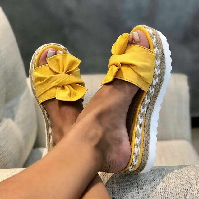 Women's woven wedge sandals with bow detail, feminine style and all-day comfort lift
