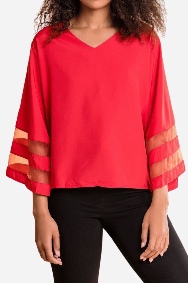 White women's V-neck bell sleeve blouse with sheer mesh panel inserts on flared 3/4 sleeves