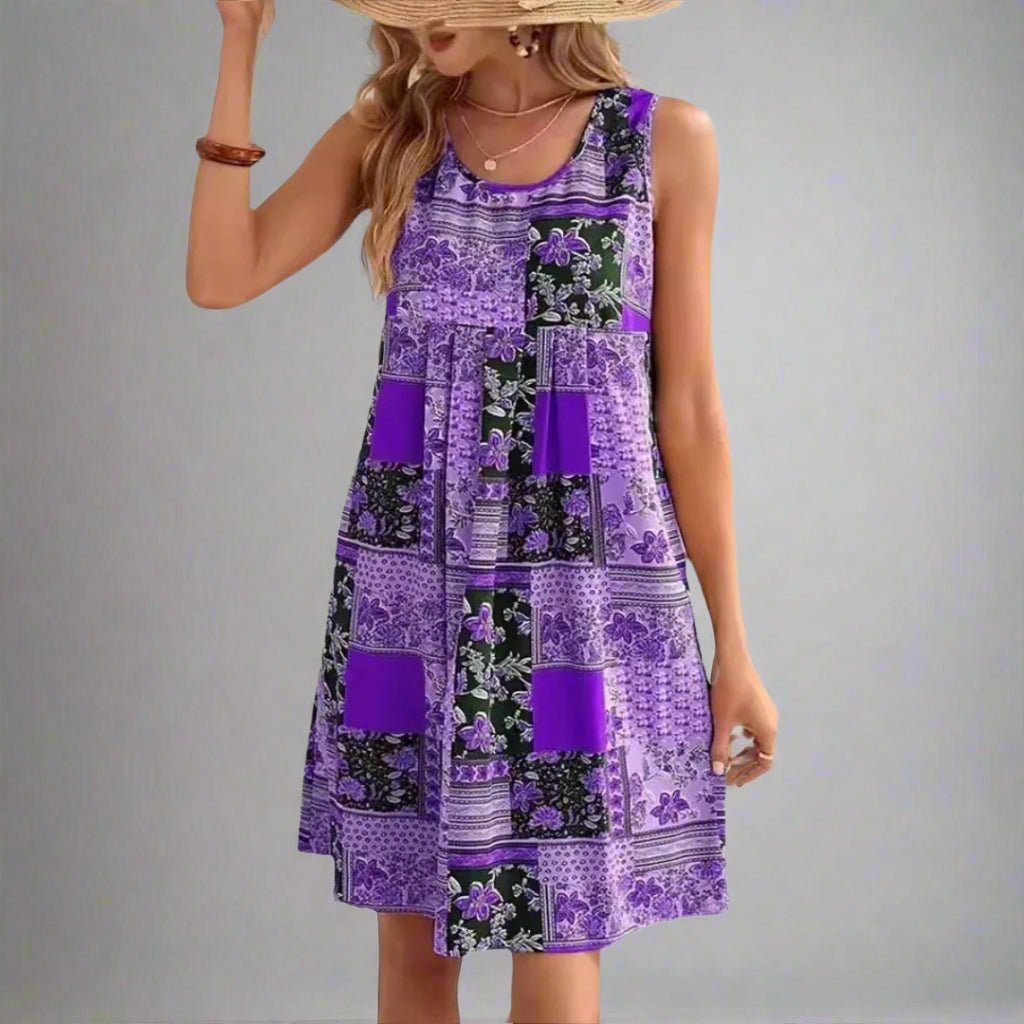Women's boho patchwork sleeveless mini dress in amber, navy, and cream with mixed floral geometric print