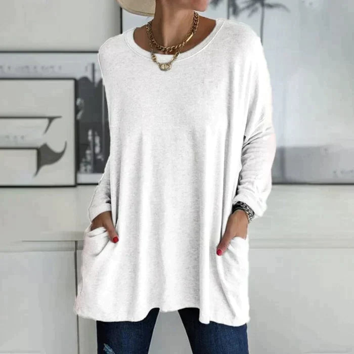 Women's oversized long sleeve tunic top with front pockets, relaxed knit fit and flared hem