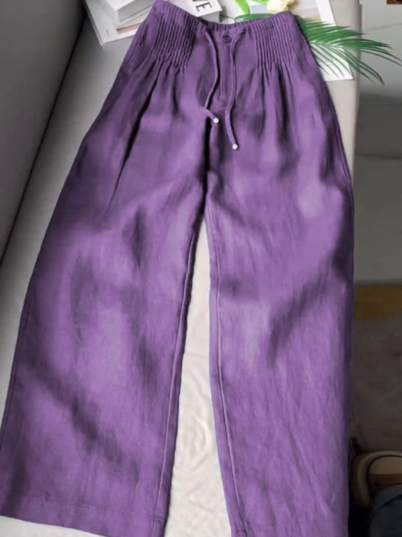 Beige wide-leg pants with relaxed fit and lightweight fabric that elongates the silhouette