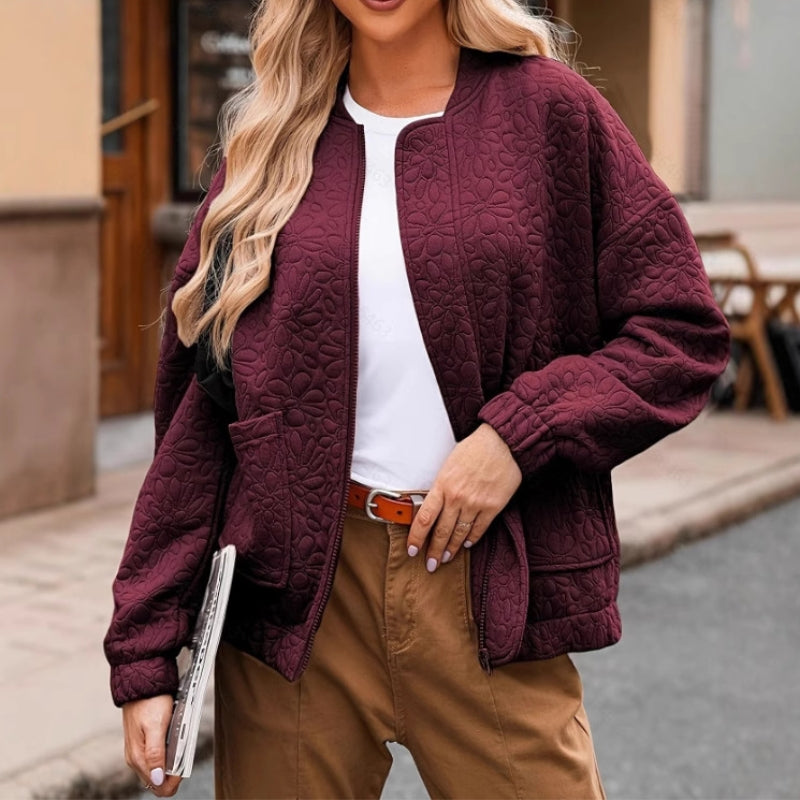Ferine padded quilted jacket in neutral tone, clean-line silhouette with functional zip closure and roomy pockets