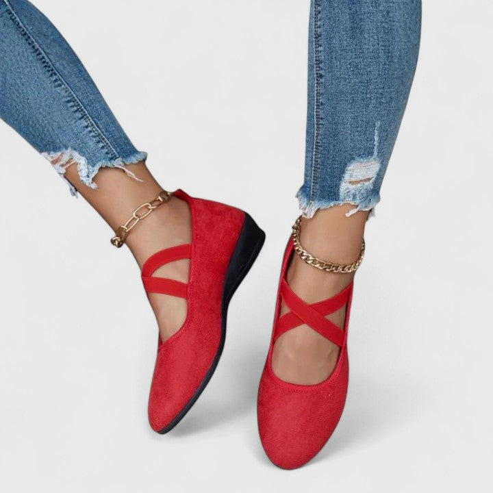 Women's black suede cross-strap wedge flats with low hidden wedge and sleek everyday elegant design