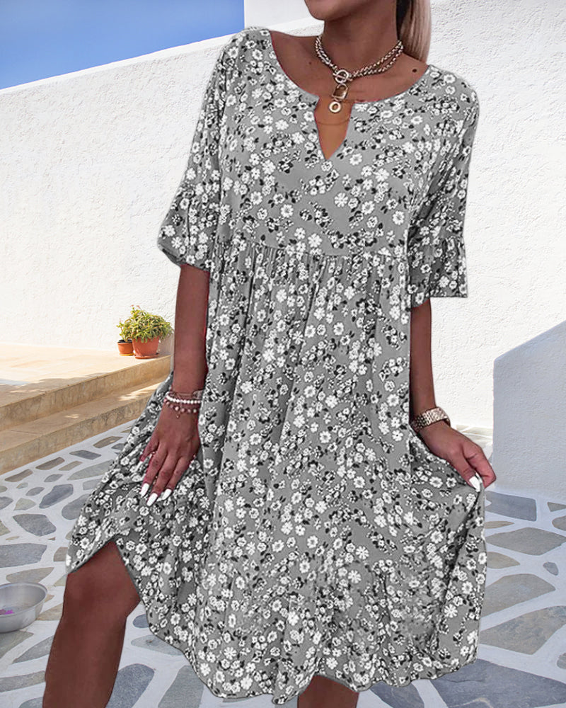 Women's floral print midi dress with V-neck, short sleeves, and smocked waist in ditsy print