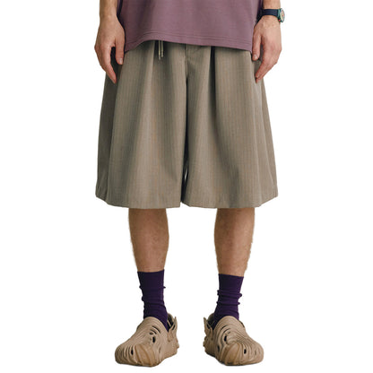 Mono wide-leg pleated shorts in neutral tone with drawstring waist and fluid structured drape