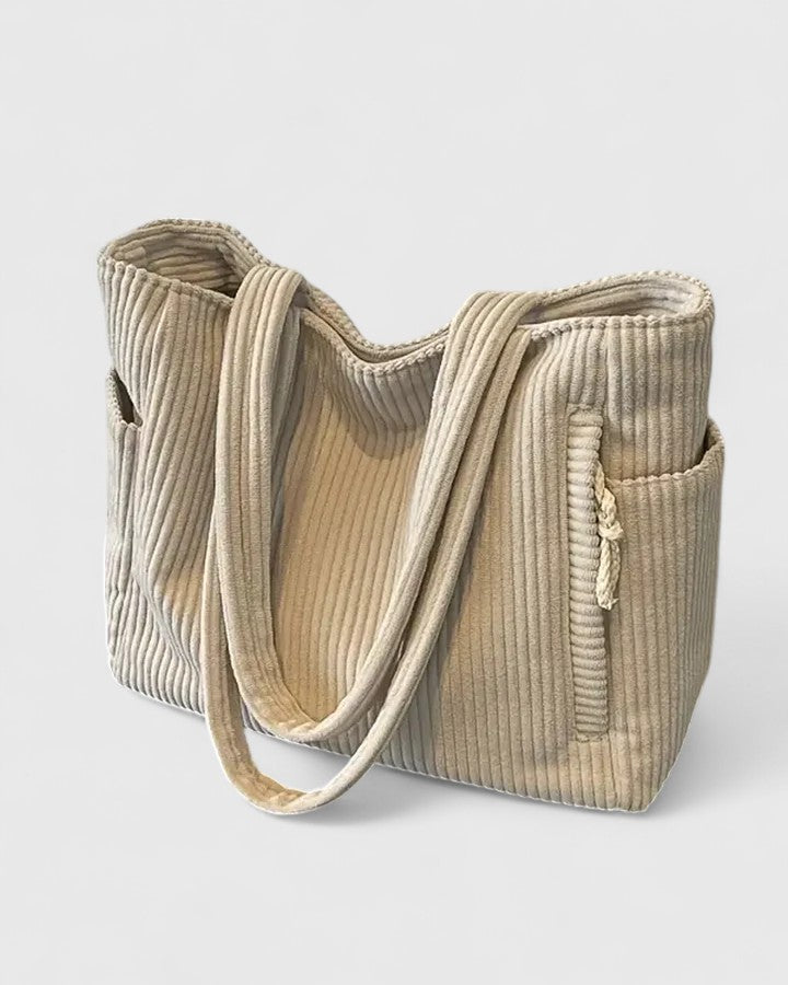 Luxurious ribbed structured handbag in neutral tone, spacious silhouette with distinctive textured finish