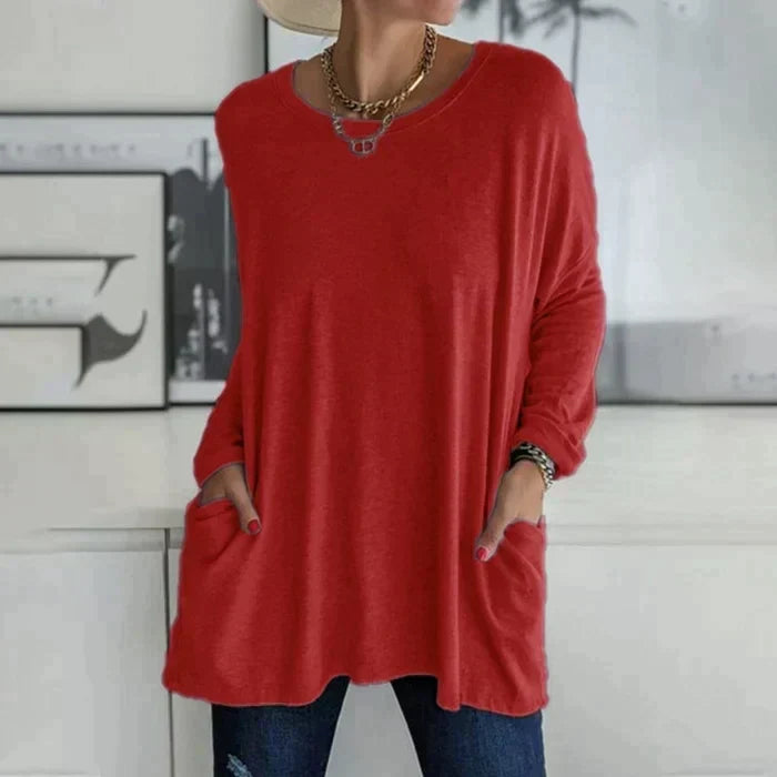 Women's oversized long sleeve tunic top with front pockets, relaxed knit fit and flared hem
