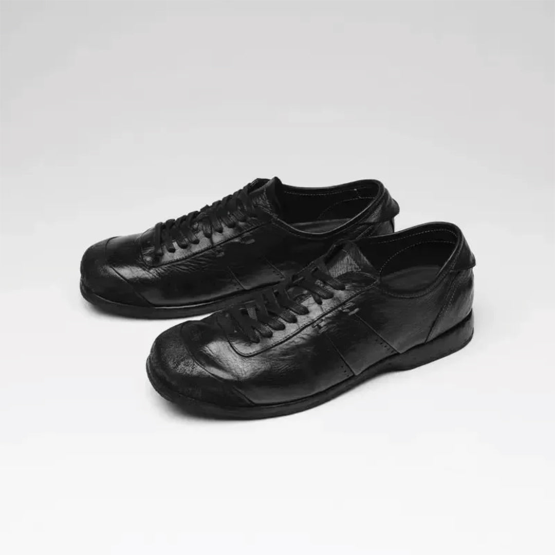 White low-top court sneaker with vegan leather accents and subtle stitchwork for minimal street style