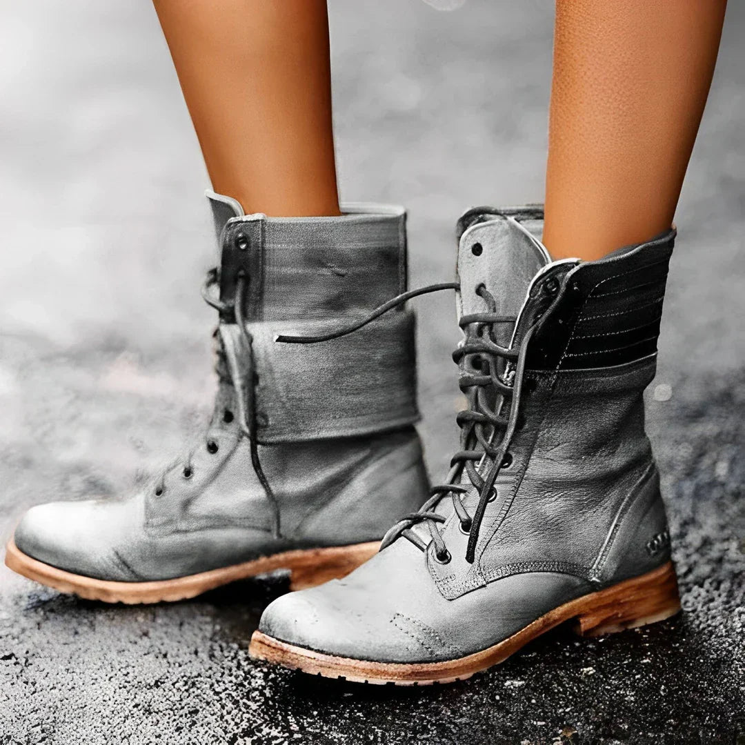 Women's black lace-up combat boots with cushioned insole and durable metal eyelets for all-day wear