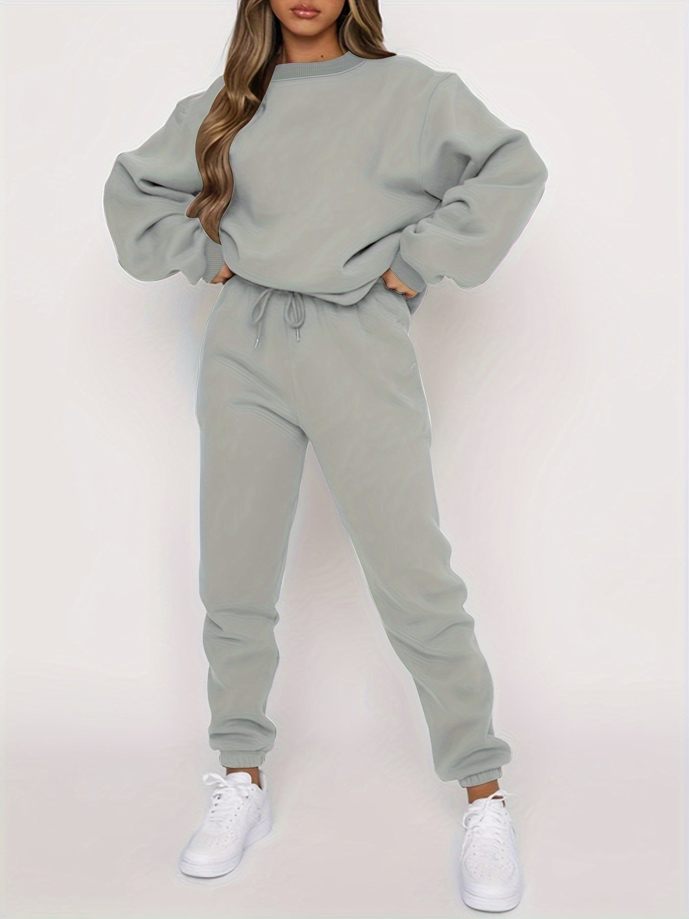 Women's gray oversized sweatshirt and high-waisted jogger set with relaxed casual fit