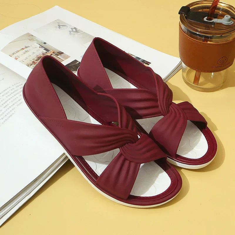 Women's beige knot-detail flat sandals with cushioned sole and minimalist elegant design