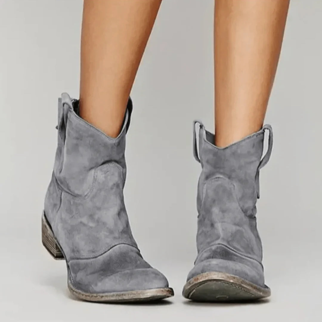 Soft blue suede Western curve boots with sculpted silhouette and pull tabs for easy wear