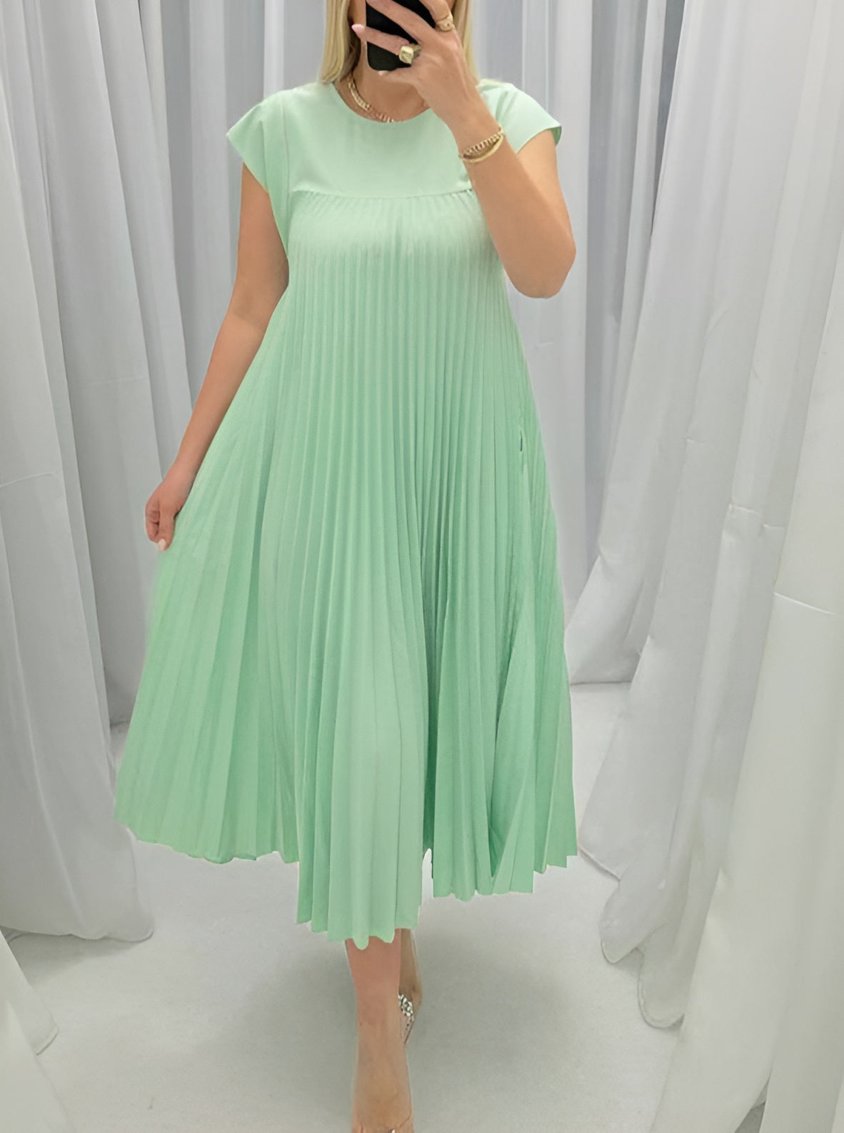 Women's elegant pleated evening dress with graceful flowing silhouette and flattering structured fit