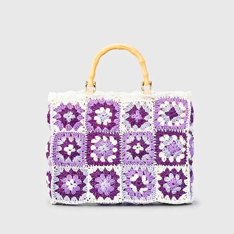 Handmade boho crochet tote bag with vibrant patchwork and woven bamboo handle, eco-friendly