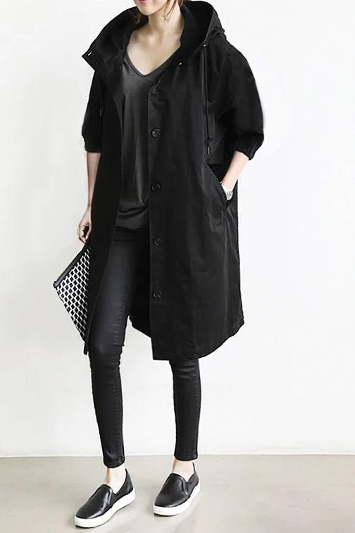 Women's beige hooded trench coat with classic double-breasted front and elegant tailored silhouette