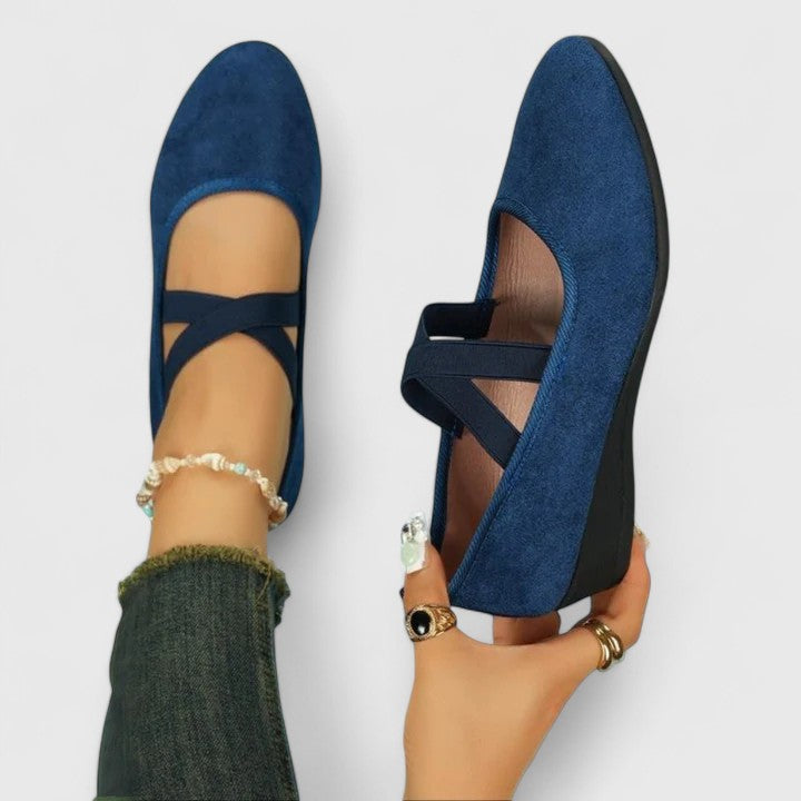 Women's black suede cross-strap wedge flats with low hidden wedge and sleek everyday elegant design