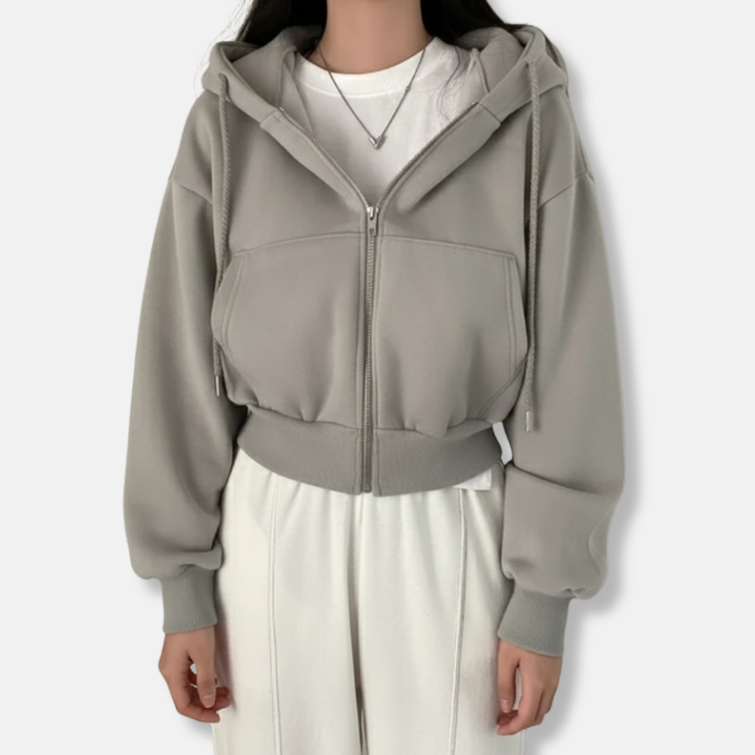 Women's oversized zip-up hoodie in neutral tones, fleece-lined with kangaroo pocket for cozy everyday style