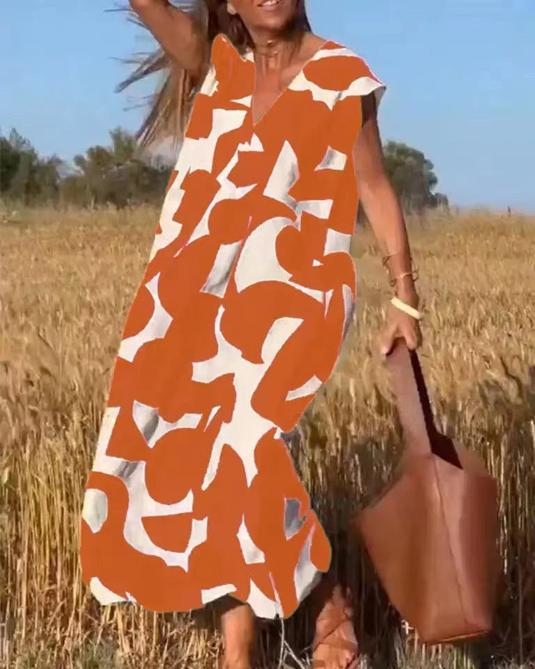 Women's flowy maxi dress with abstract print, lace detailing, and elegant flowing silhouette