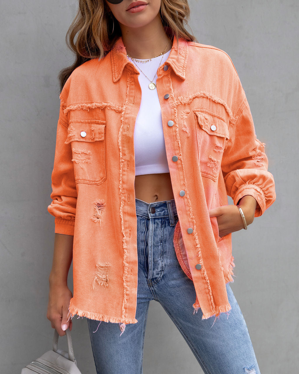 Women's oversized beige shirt jacket with relaxed fit and distressed detailing for urban style