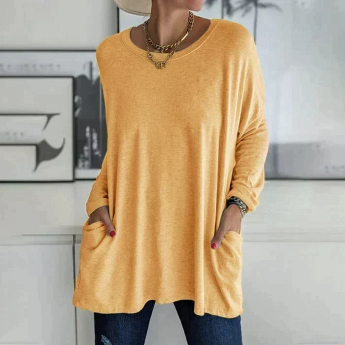 Women's oversized long sleeve tunic top with front pockets, relaxed knit fit and flared hem