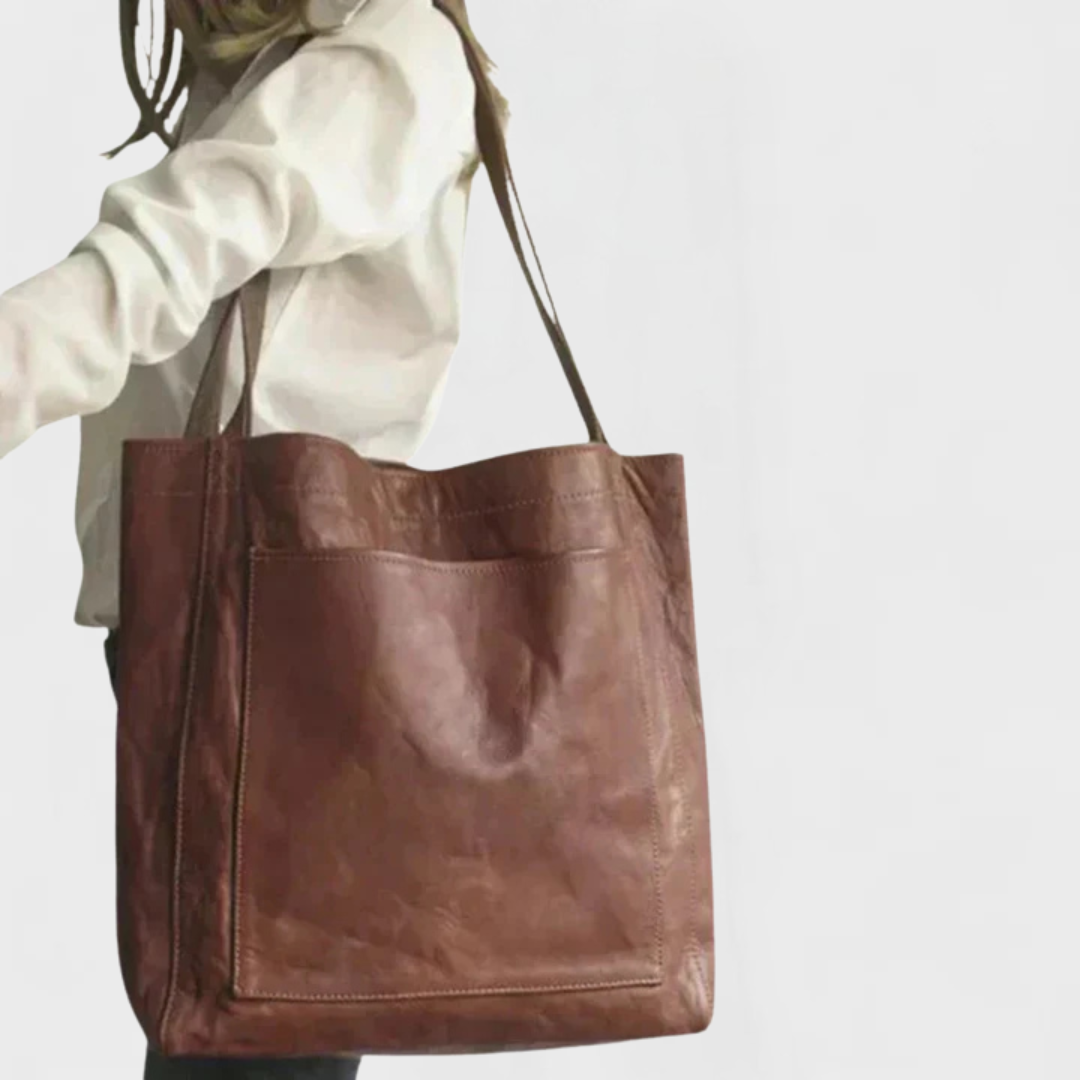 Minimalist black tote bag with spacious silhouette and clean structured design for daily use