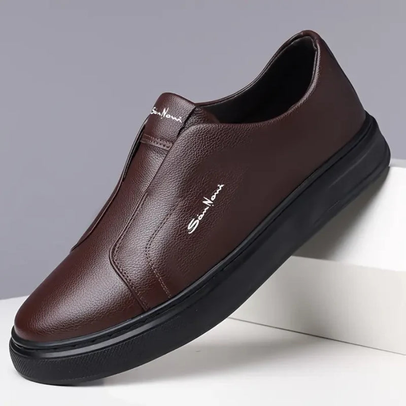 White vegan leather slip-on sneakers with minimalist silhouette and cushioned sole