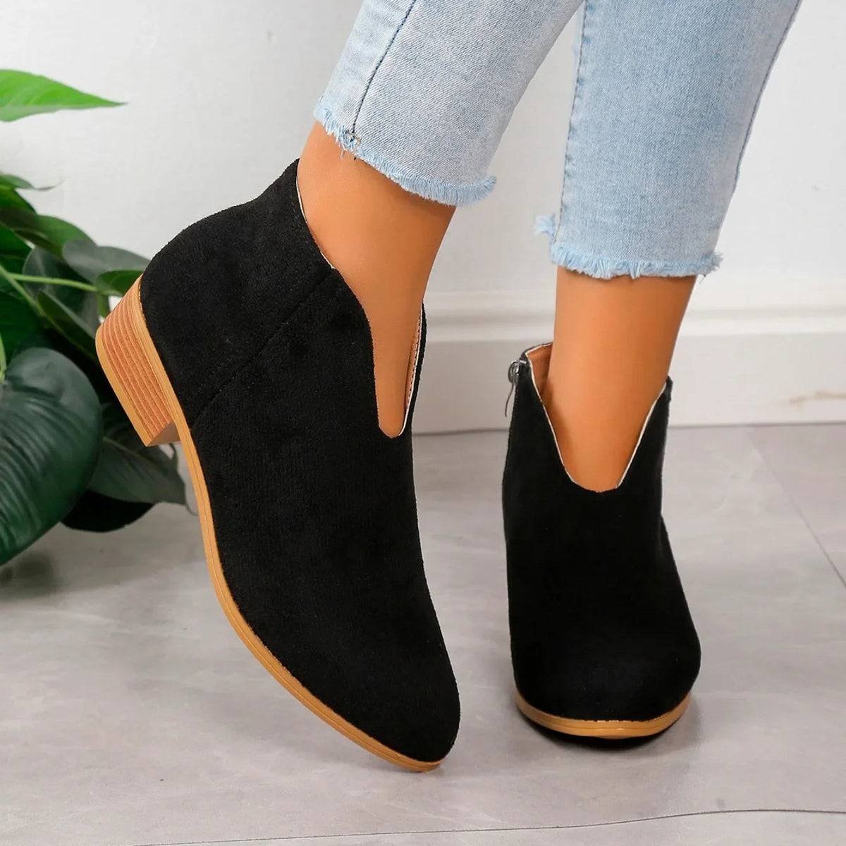 Women's leopard print ankle boots with sleek side zipper closure, bold animal pattern, edgy chic style