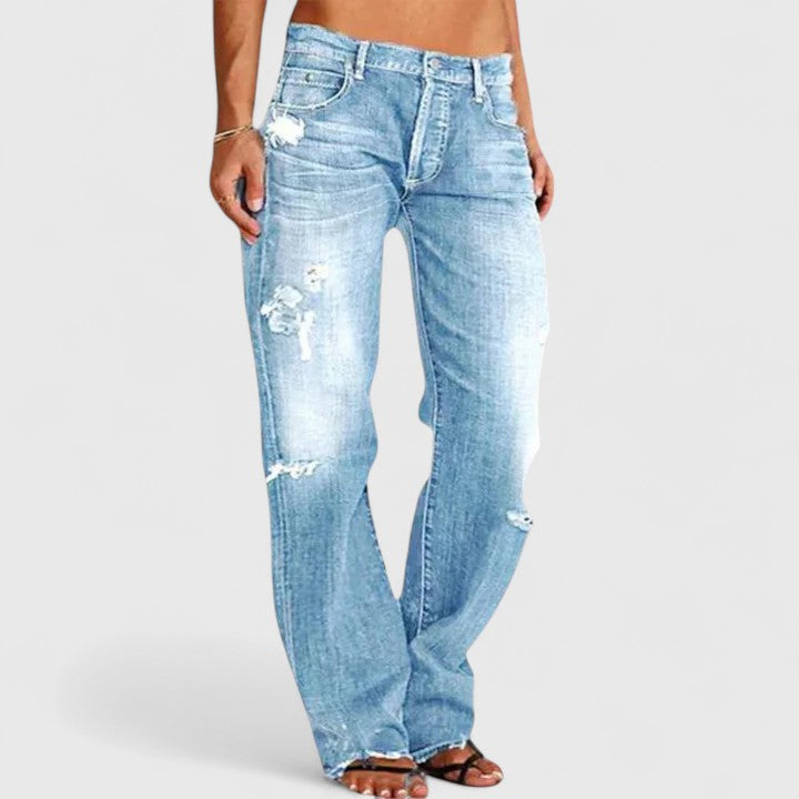 Women's low rise straight leg distressed jeans with authentic rip-and-fade denim detailing