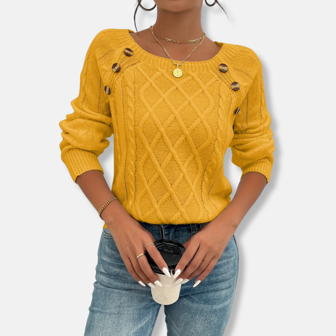 Women's cream cable knit relaxed fit top with dropped shoulders, button accents, and ribbed cuffs