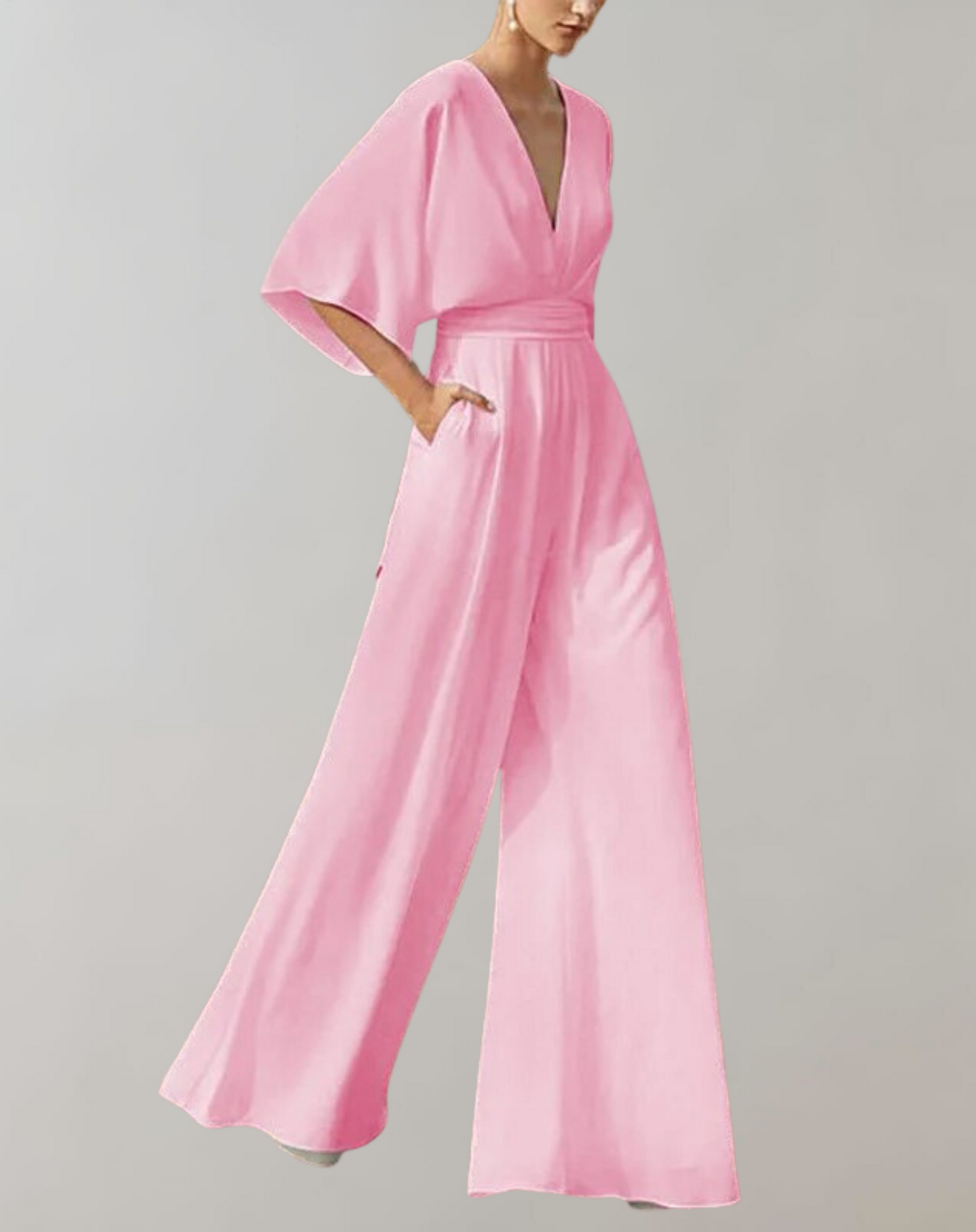 Blush pink wide-leg jumpsuit with plunging V-neck and dramatic batwing sleeves for formal occasions