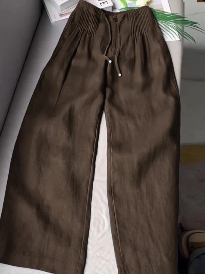 Black wide-leg pants with relaxed fit and lightweight fabric that elongates the silhouette