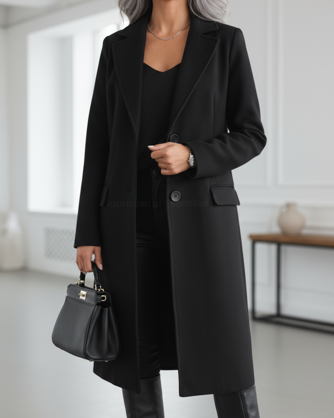 Elegant long tailored coat in classic tone with structured waist-defining silhouette and timeless refined cut