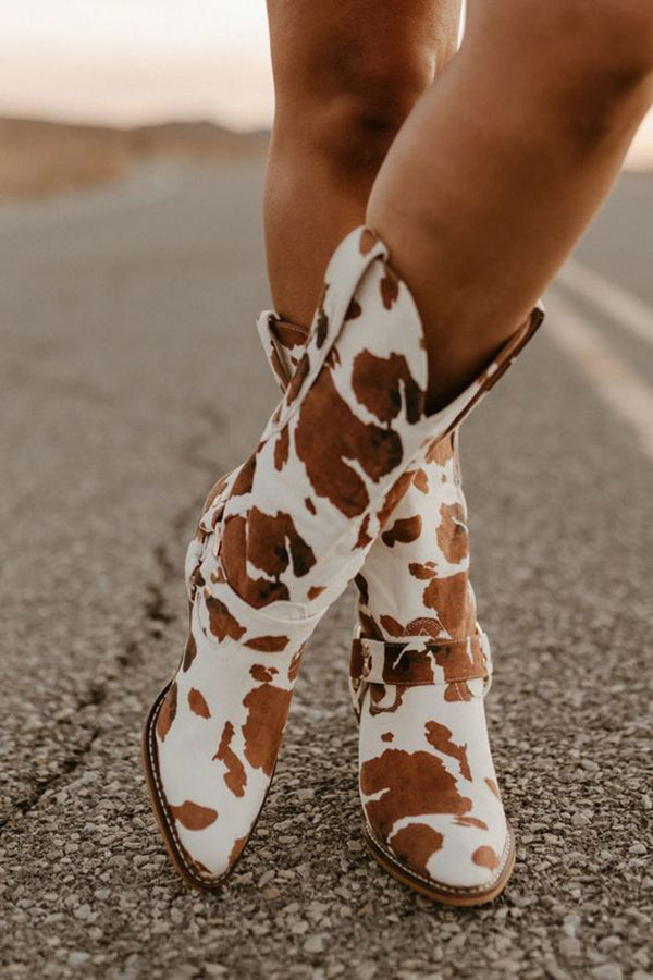 Women's black white cow print western boots with bold belt accent detail