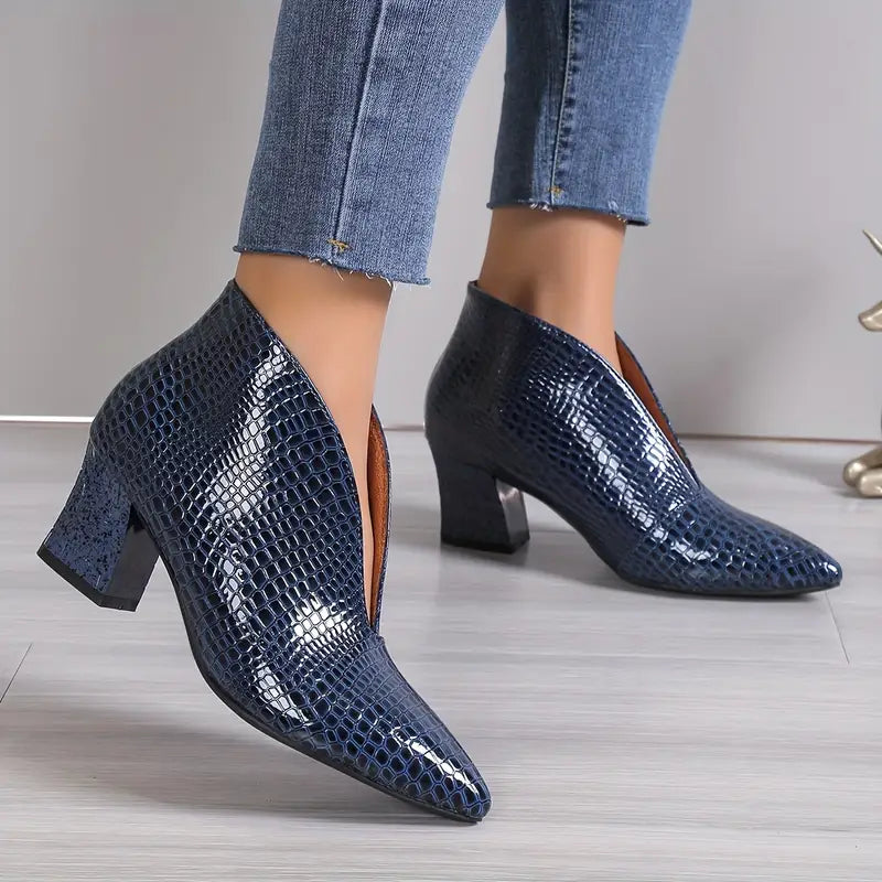 Women's black reptile-textured ankle boots with exotic embossed exterior and sleek silhouette