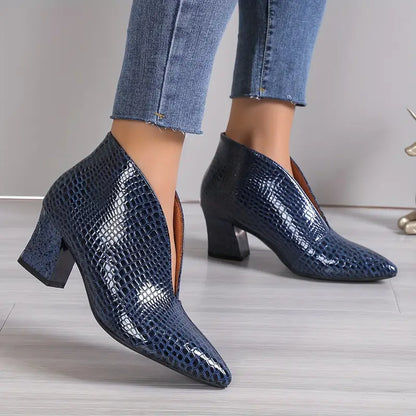 Women's black reptile-textured ankle boots with exotic embossed exterior and sleek silhouette