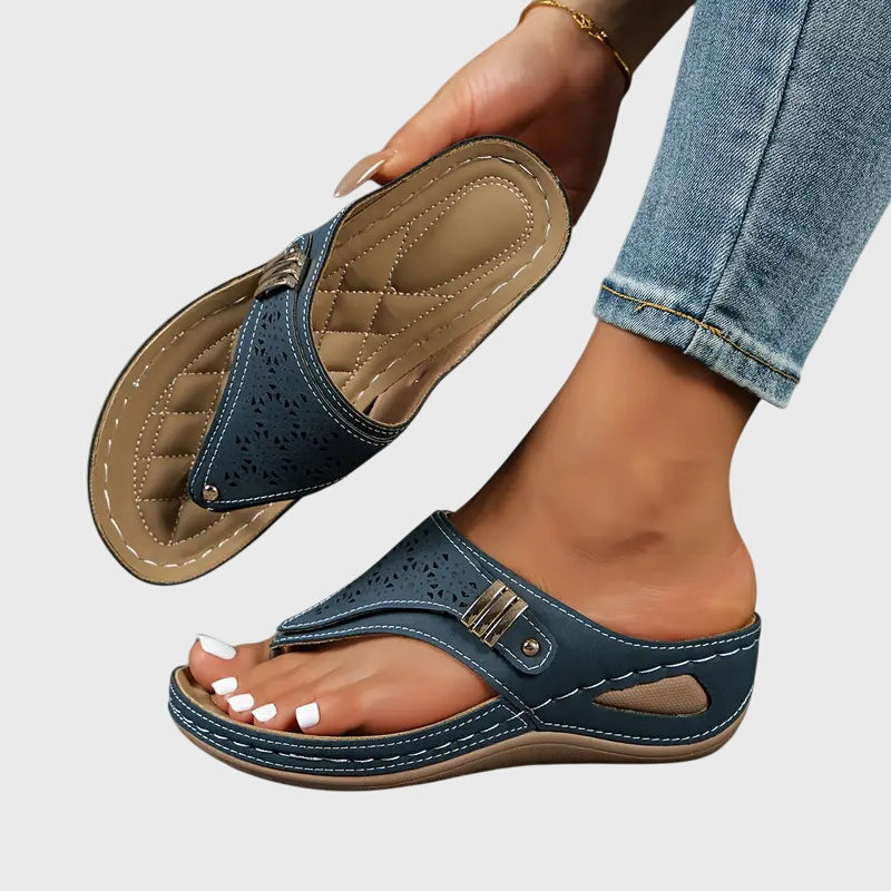 Women's wedge toe loop sandals in neutral tone with intricate floral laser-cut upper detail