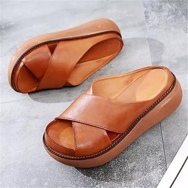 Women's flat cushioned X-strap sandals in neutral tones with elegant crossing strap design