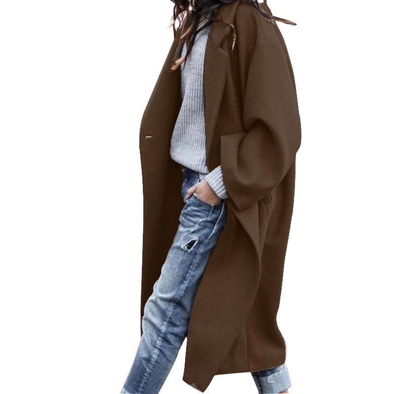 Women's minimalist long coat in neutral tones, elegant notch lapel silhouette with functional side pockets
